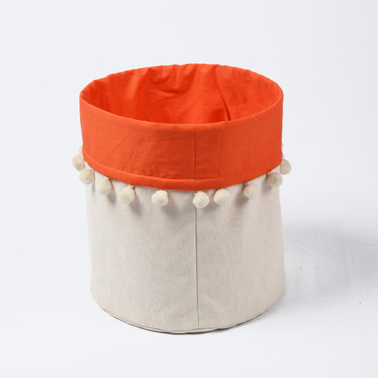 Canvas storage basket with orange cotton lining and pompoms, sizes available