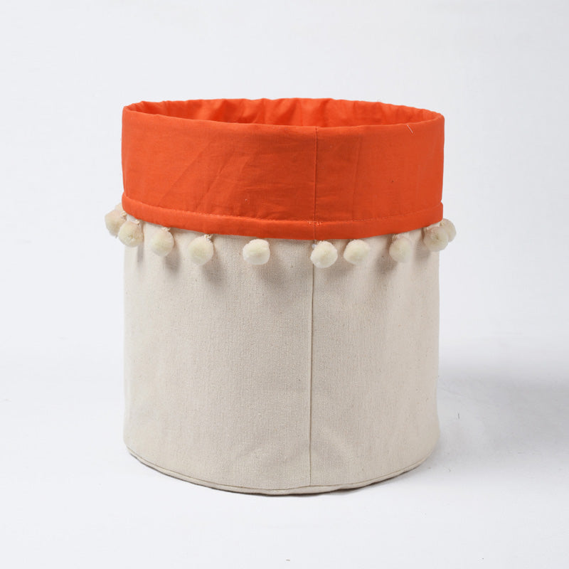Canvas storage basket with orange cotton lining and pompoms, sizes available