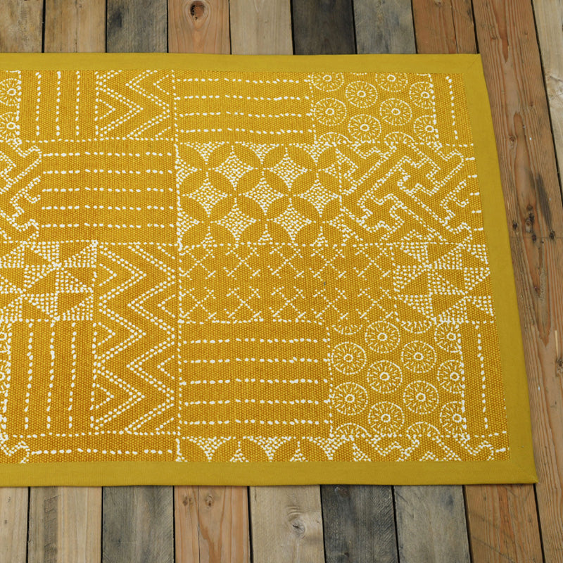 Cotton printed rug in mustard colour with geometric print