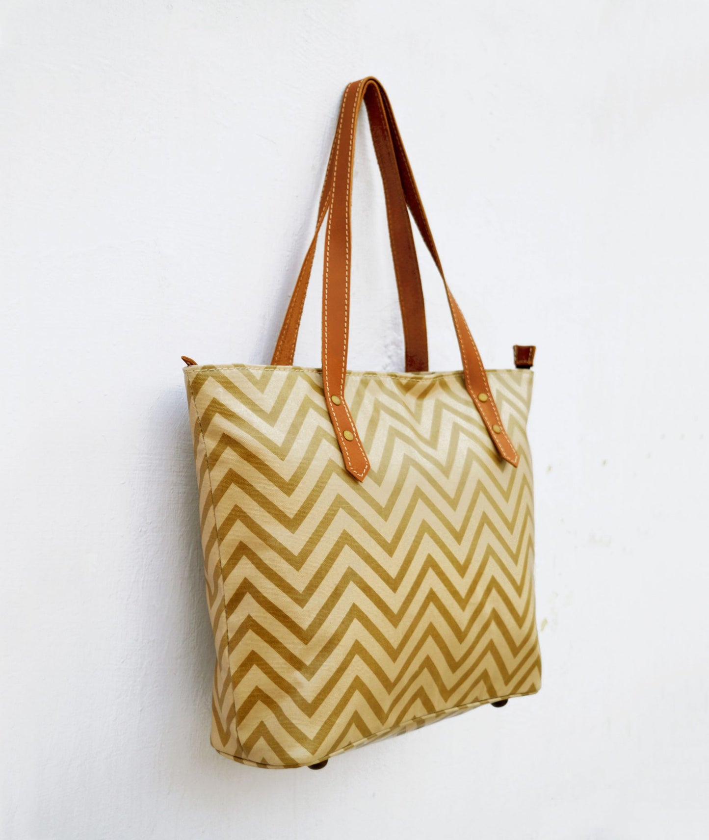 Beige Tote bag, laminated cotton, chevron print, sheen finish, leather trims, zip closure, everyday bag.