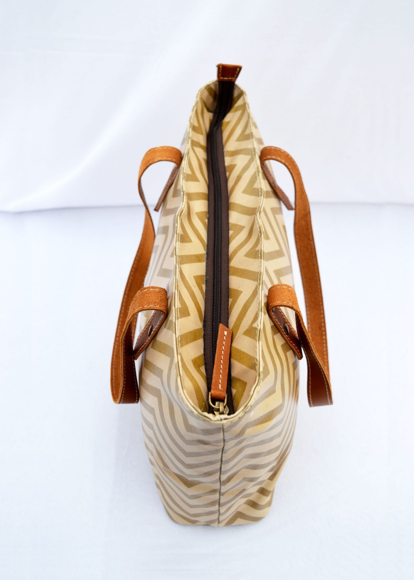 Beige Tote bag, laminated cotton, chevron print, sheen finish, leather trims, zip closure, everyday bag.