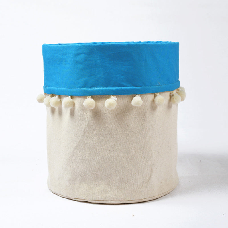 Canvas storage basket with blue cotton lining and pompoms, sizes available