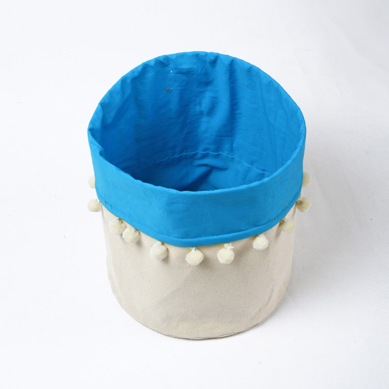 Canvas storage basket with blue cotton lining and pompoms, sizes available