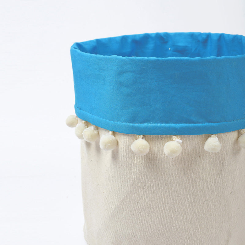 Canvas storage basket with blue cotton lining and pompoms, sizes available
