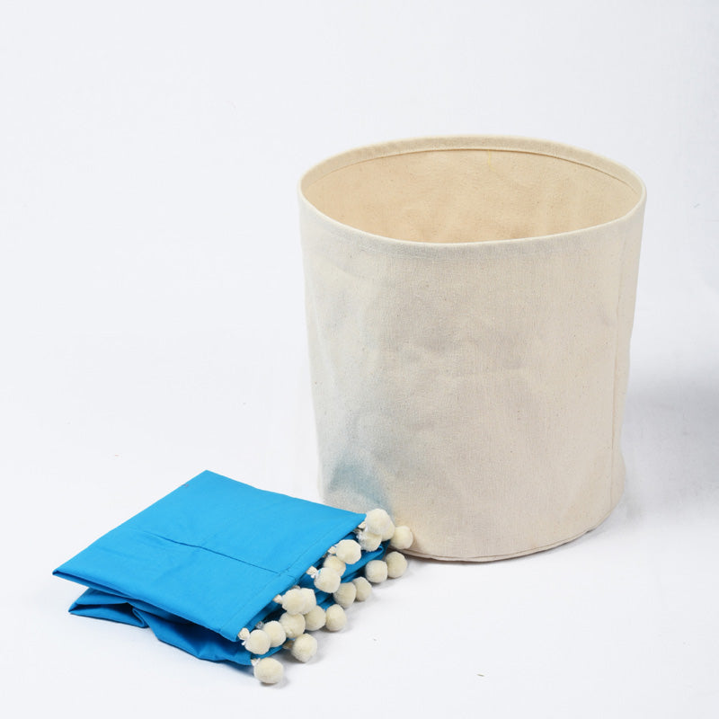 Canvas storage basket with blue cotton lining and pompoms, sizes available
