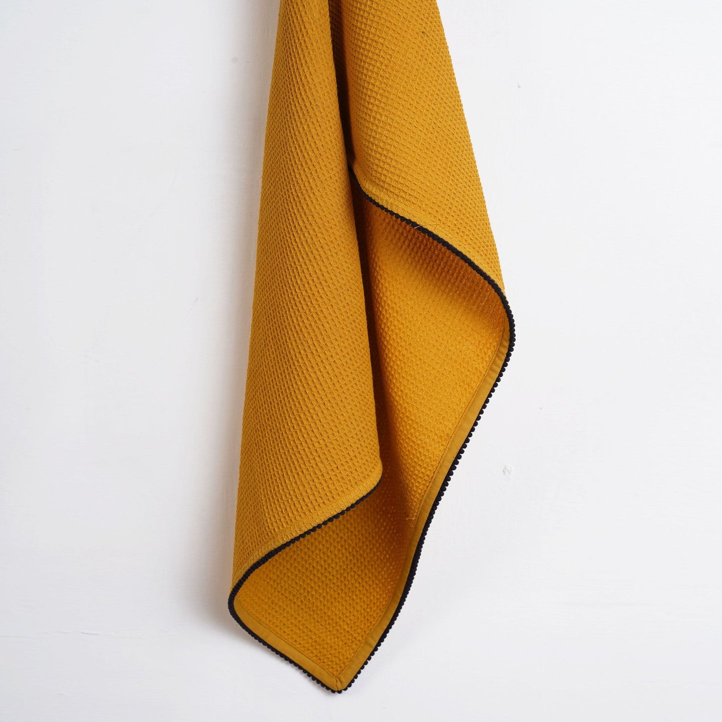 MODERN RETRO - Mustard yellow waffle napkin with black micro pompom lace edging.