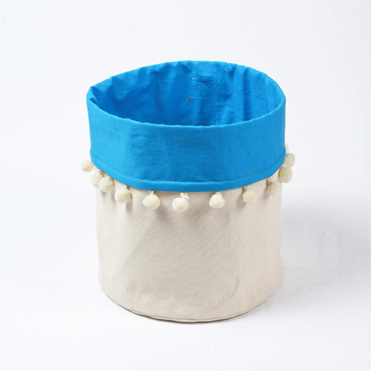 Canvas storage basket with blue cotton lining and pompoms, sizes available