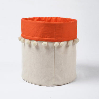 Canvas storage basket with orange cotton lining and pompoms, sizes available