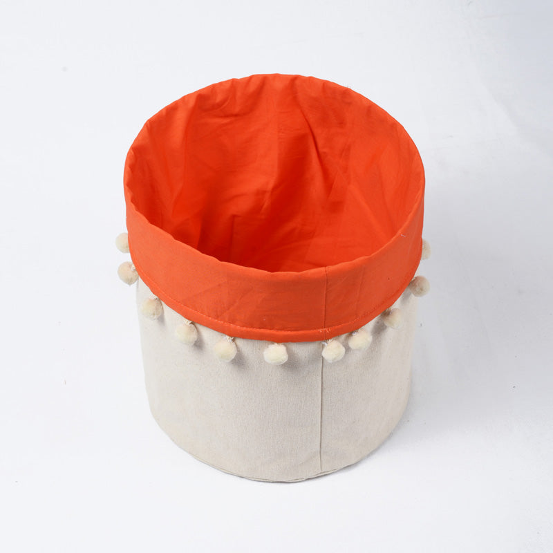 Canvas storage basket with orange cotton lining and pompoms, sizes available
