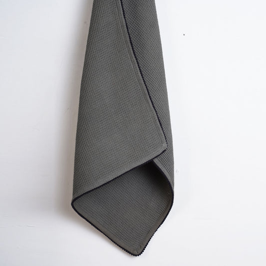 MODERN RETRO - Grey waffle napkin with black micro pompom lace edging.