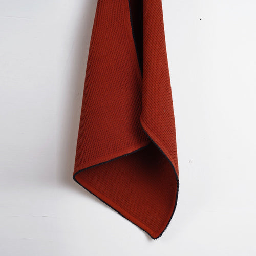 MODERN RETRO - Terracotta waffle napkin with black micro pompom lace edging.