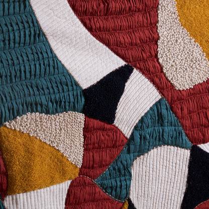 Vliving abstract textile wall art with teal, red, gold, ivory, black, and brown patchwork in bouclé, embroidery, and quilting.