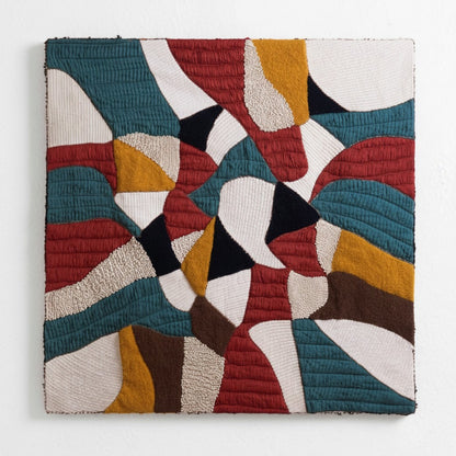 Vliving abstract patchwork textile wall art with teal, red, mustard gold, ivory, black, and brown textured fabrics.