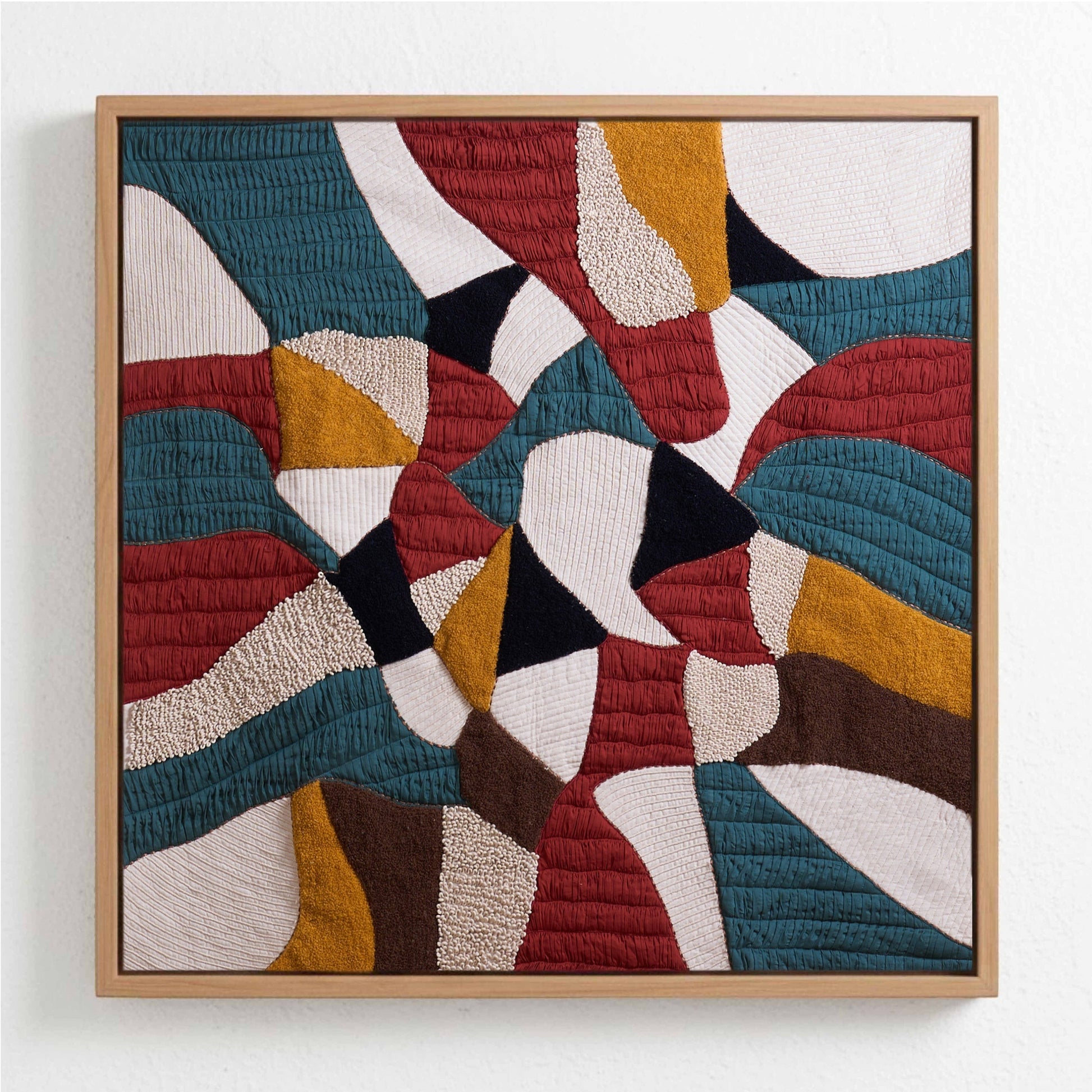 Vliving abstract patchwork textile wall art with teal, red, gold, ivory, black, and brown textured fabric.