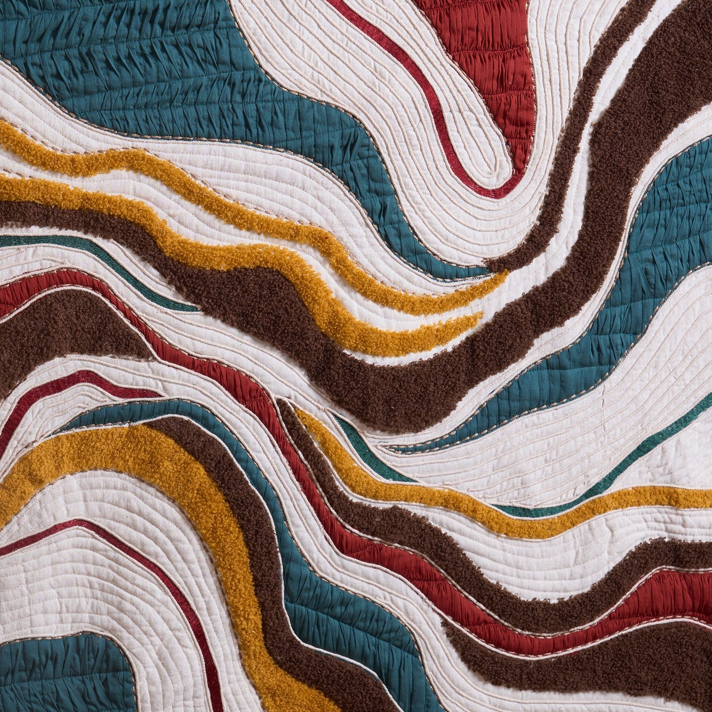 Vliving abstract textile wall art with wavy lines in teal, red, mustard, ivory, black, and brown.