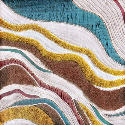 Vliving abstract textile wall art with wavy bands of teal, red, mustard gold, ivory, black, and brown.