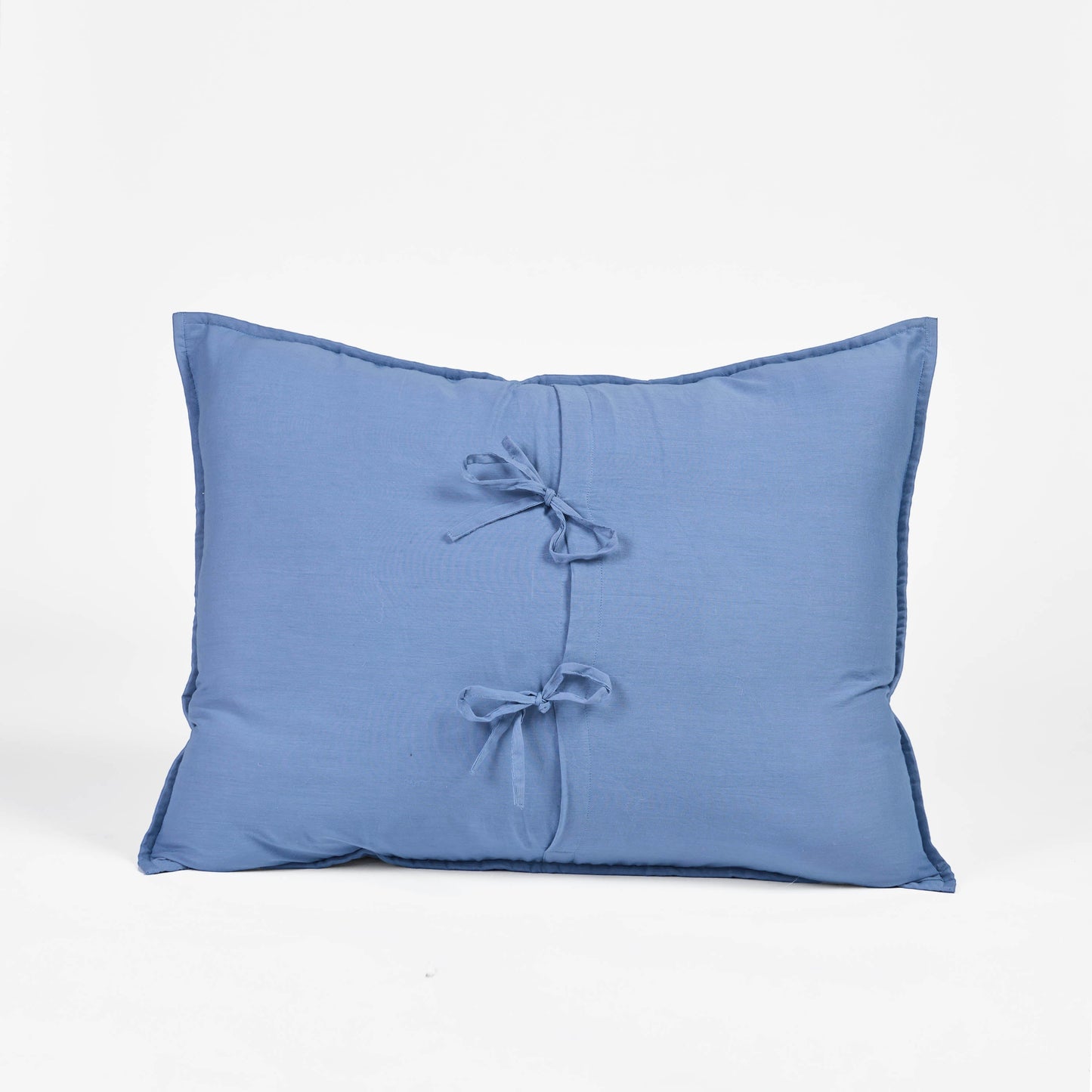 Vliving denim blue cotton voile pillow cover with tie closure and hand-stitched detail.