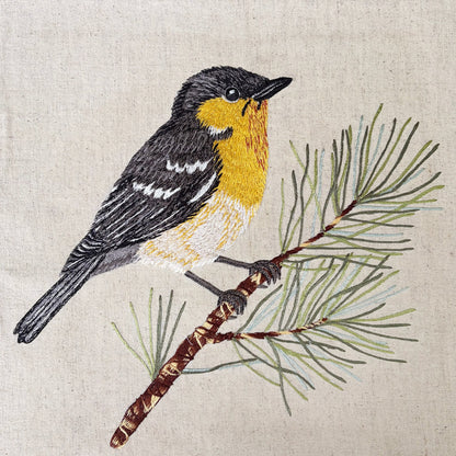 Vliving yellow and grey embroidered bird on pine branch, linen fabric with wooden frame. Botanical art.