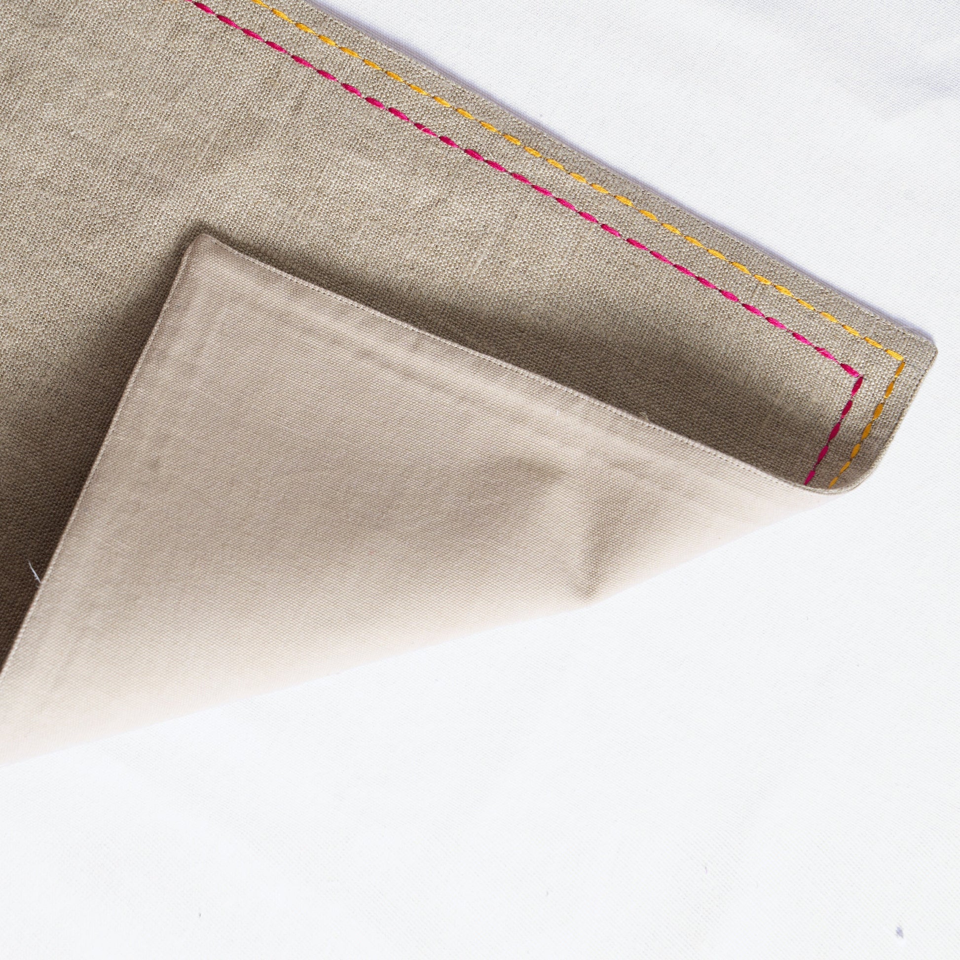 Vliving beige linen placemat with multicolour silk thread embroidery on the border.