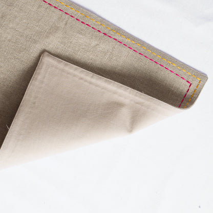 Vliving beige linen placemat with multicolour silk thread embroidery on the border.