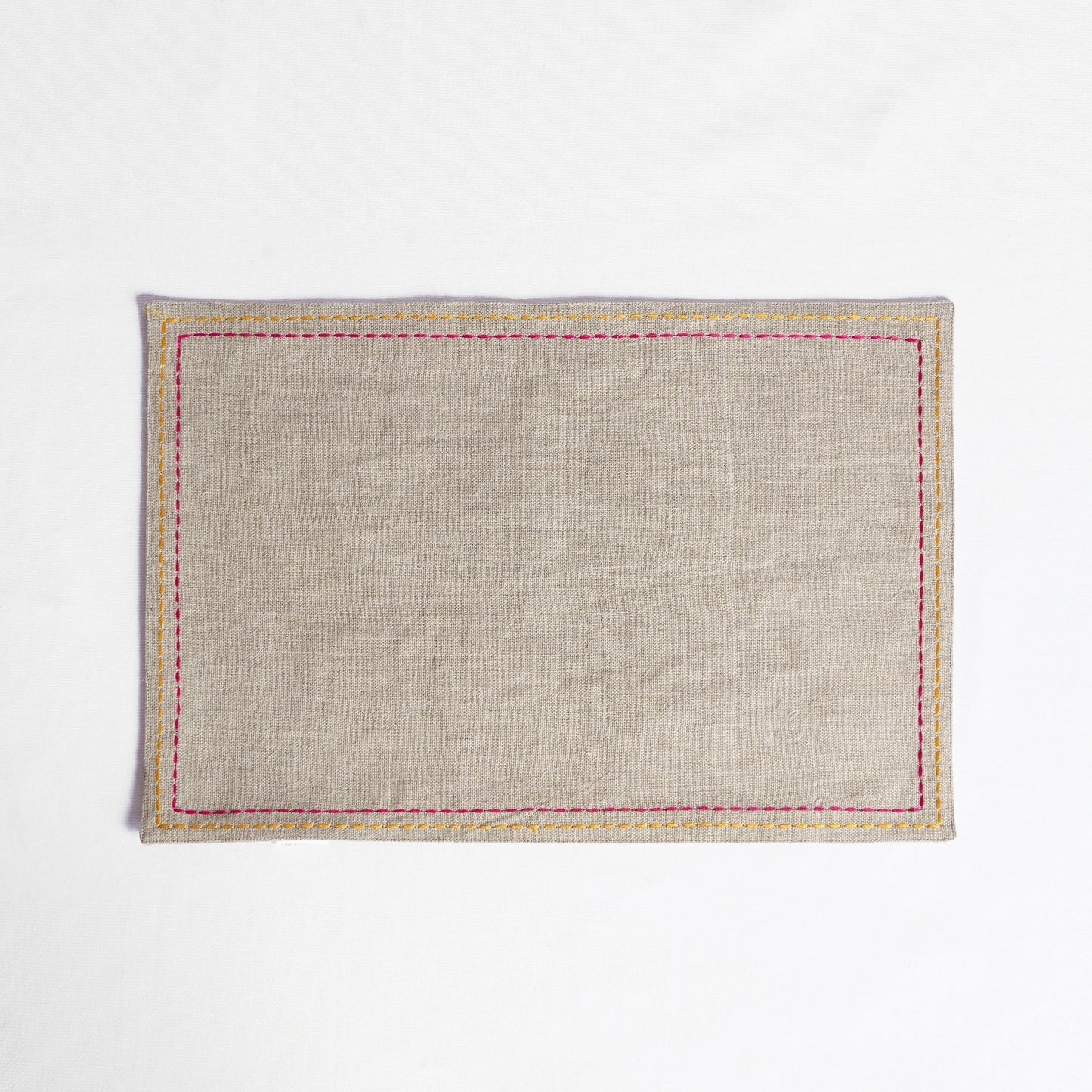 Vliving beige linen placemat with multicolour silk thread embroidery in yellow and pink.