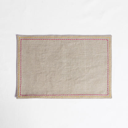 Vliving beige linen placemat with multicolour silk thread embroidery in yellow and pink.