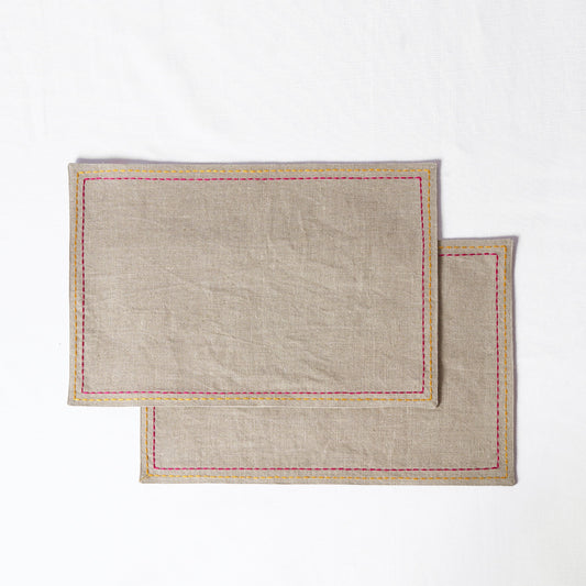 Vliving beige linen placemats with multicolour silk thread embroidery in yellow and pink.