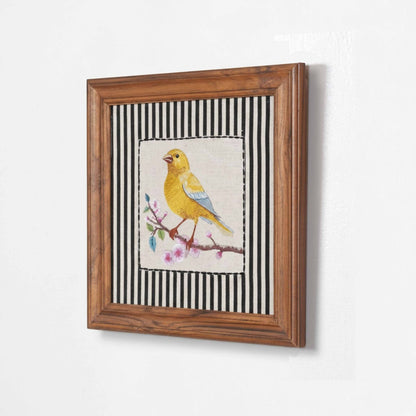 Vliving framed embroidered canary yellow bird wall art with pink blossoms on a branch, set against a black and white striped background.