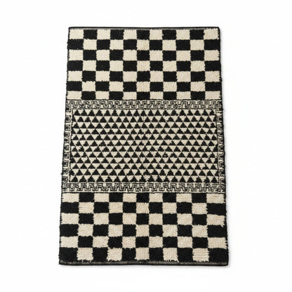 Vliving black and white hand-knotted Moroccan wool blend carpet with geometric patterns and checkerboard ends.