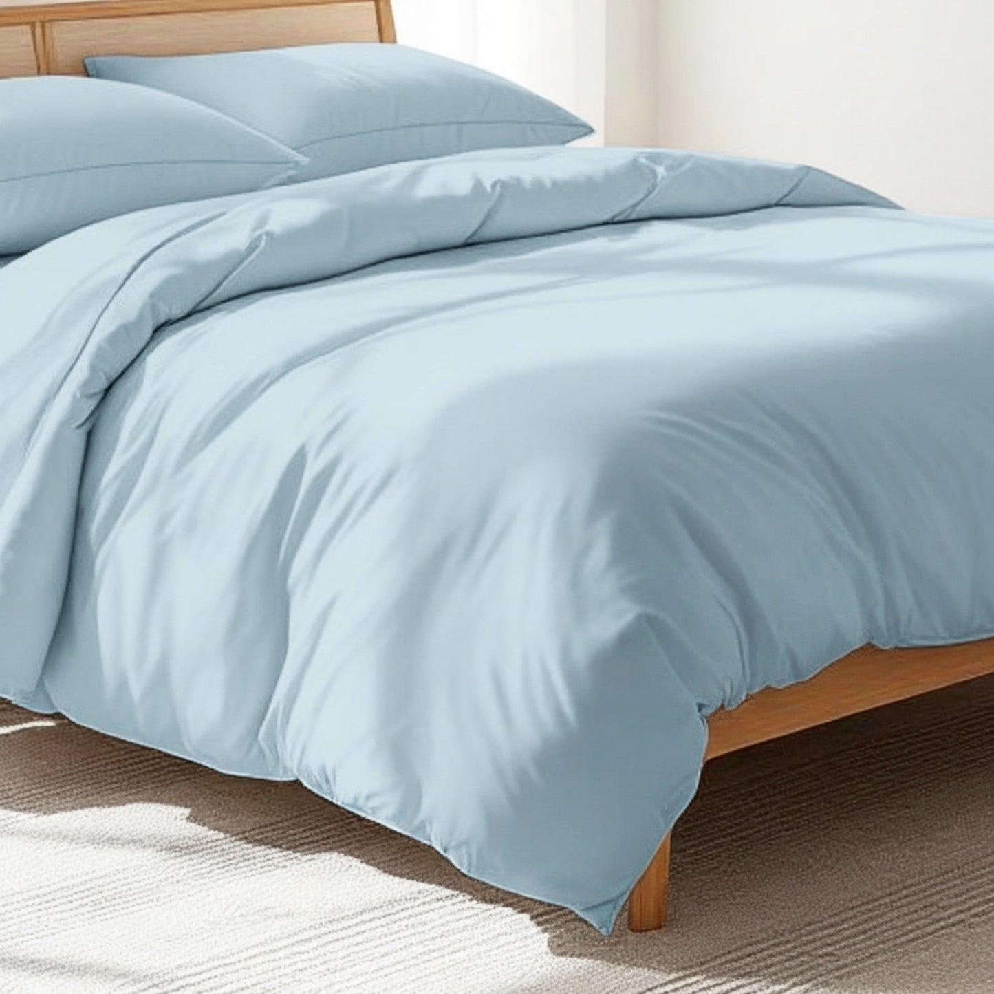 Vliving sky blue 300TC cotton percale duvet cover set with two pillowcases on a wooden bed frame.