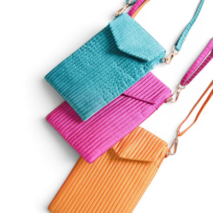 Vliving tangerine quilted crossbody phone bag with strap, made of faux silk fabric. Features magnetic closure and adjustable strap.